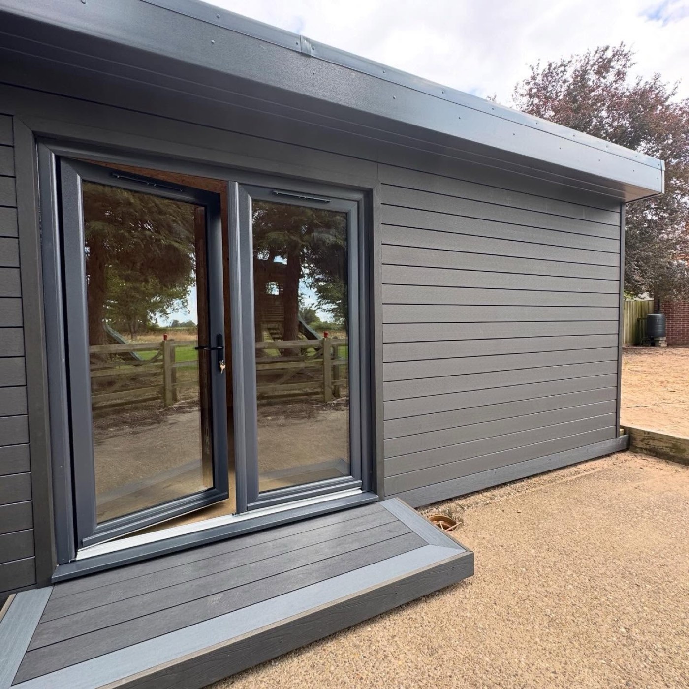After: anthracite composite garden room with double doors