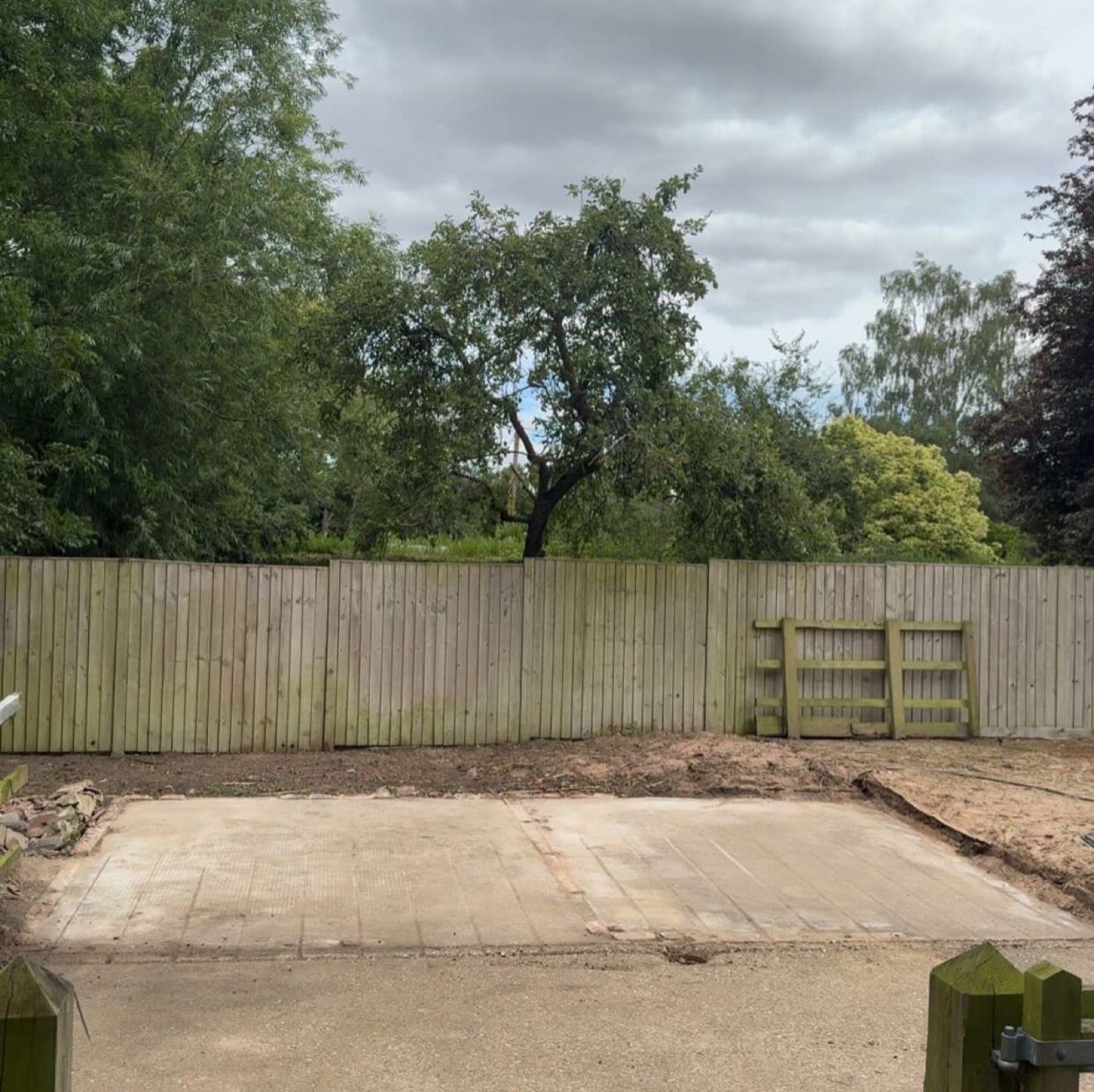 Before: bare concrete slab where horse stables stood