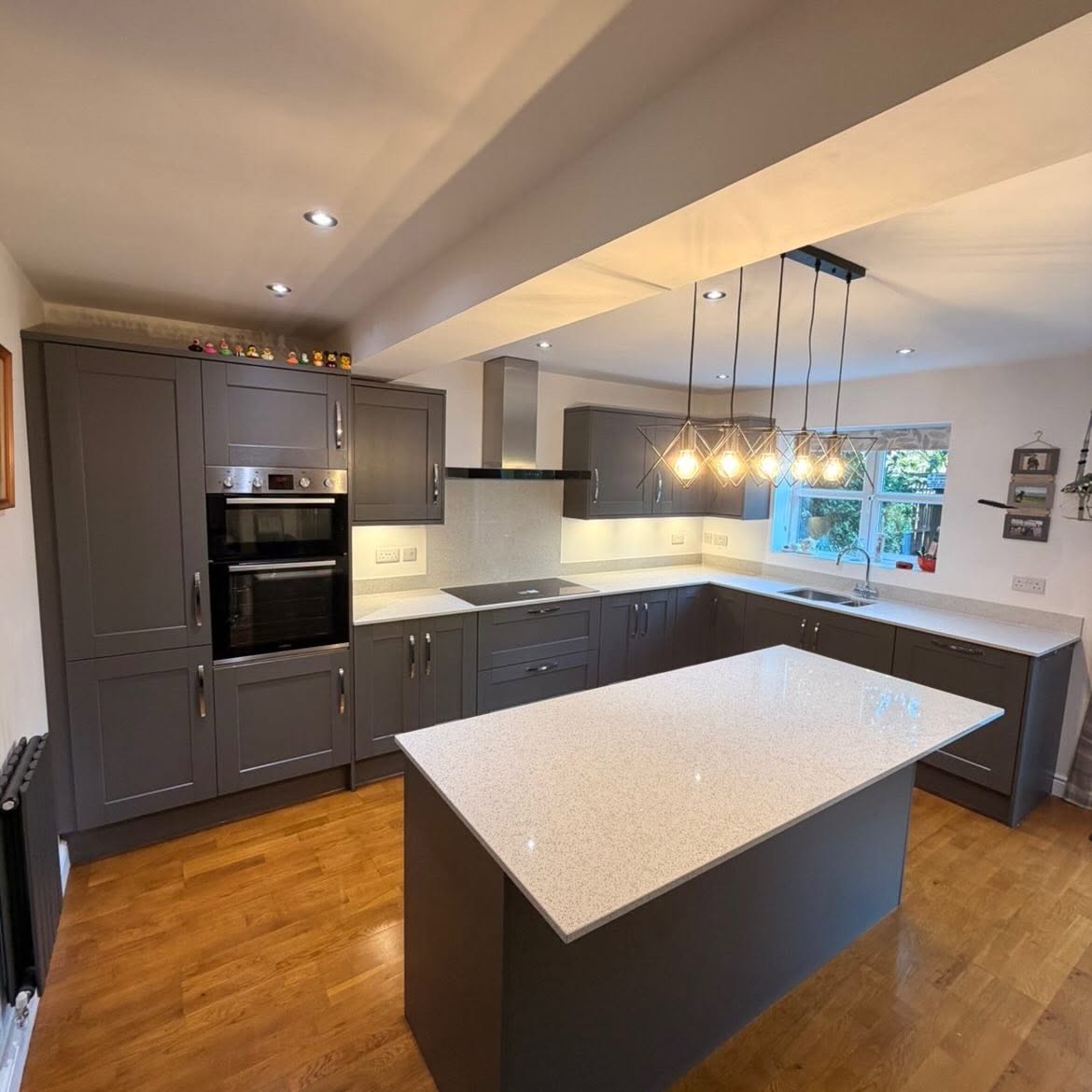 Grey shaker kitchen with white sparkle quartz worktops and island