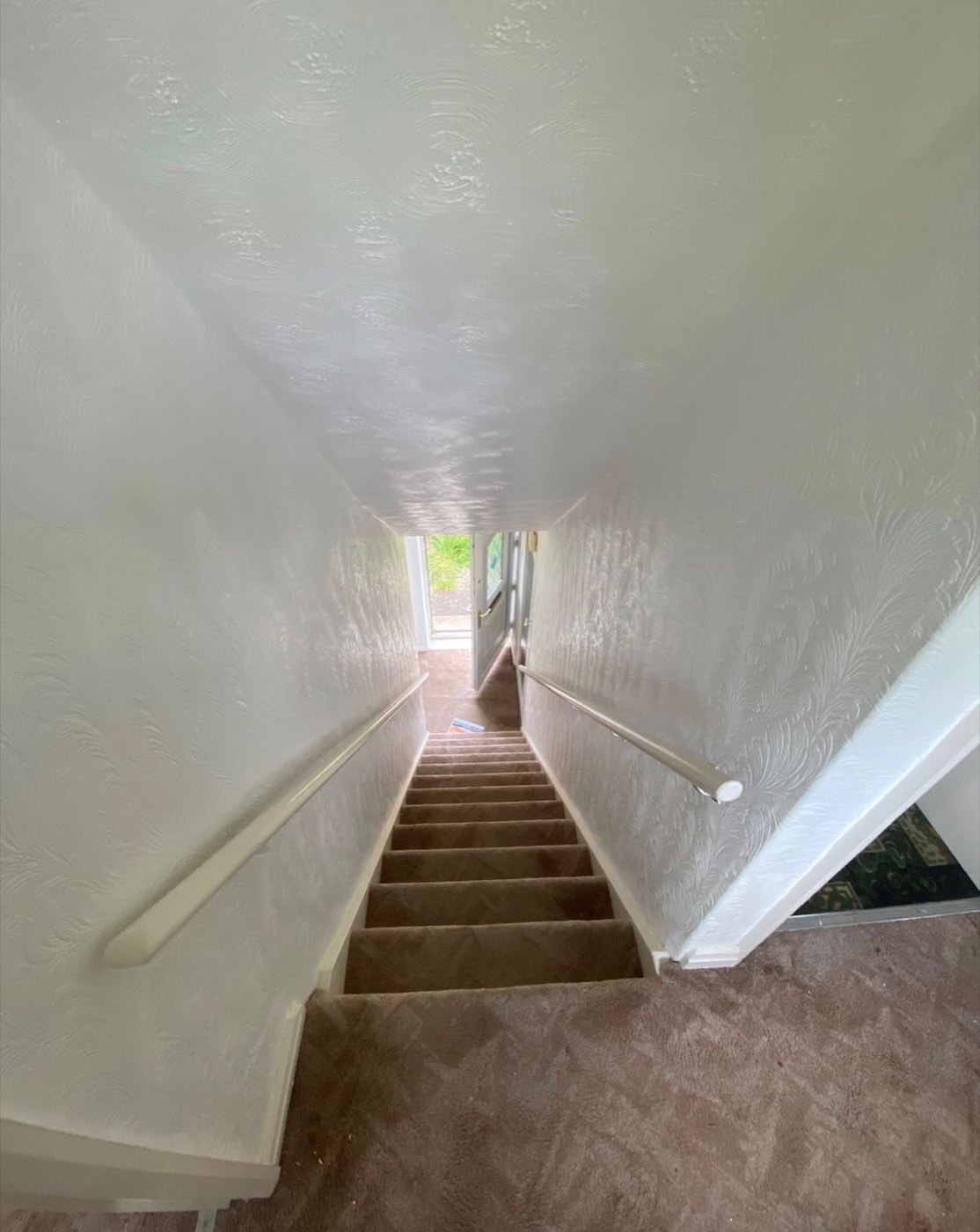 Before: boxed-in staircase with dated carpet
